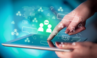 Close-up of a hand using tablet, social media concept