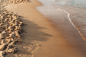 The sea meets the sand. Advertisement for a seaside resort and outdoor activities. Marine background for signature.