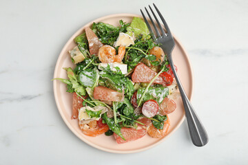 Delicious pomelo salad with shrimps served on white table, top view