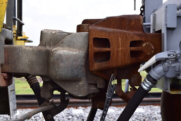 Parked train carriages zooming in on the wheels, zooming in on the hitch between carriages, carriages on a curve