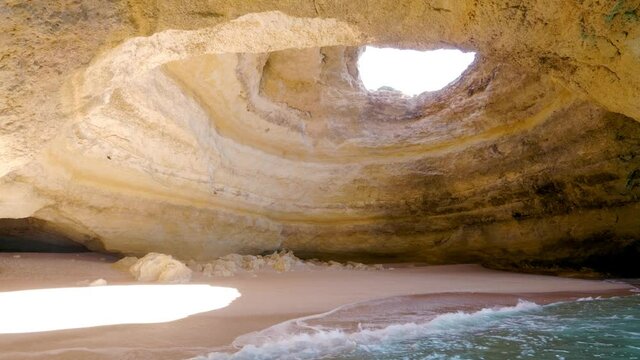 Inside the beautiful Benagil cave along the cliffs and rocks of the Albufeira coastline in Portugal