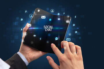 Businessman holding a foldable smartphone, social media concept