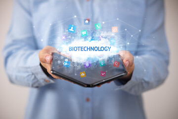 Businessman holding a foldable smartphone, technology concept