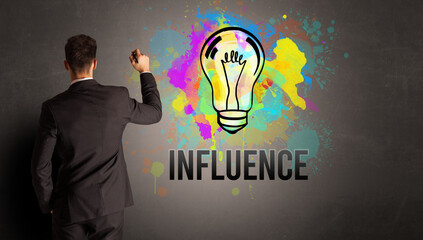 businessman drawing colorful light bulb