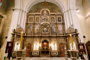 Fototapeta na wymiar Iconostasis behind the chandelier in the Church of St. Nicholas in Kotor