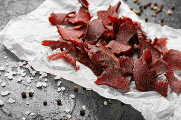 Spicy beef jerky on dark background