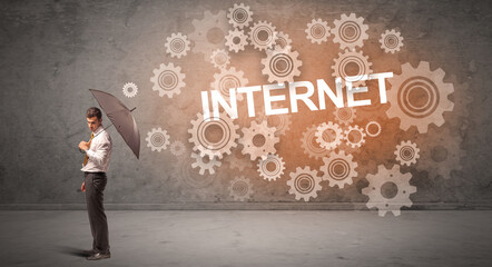 Obraz premium Businessman defending with umbrella concept