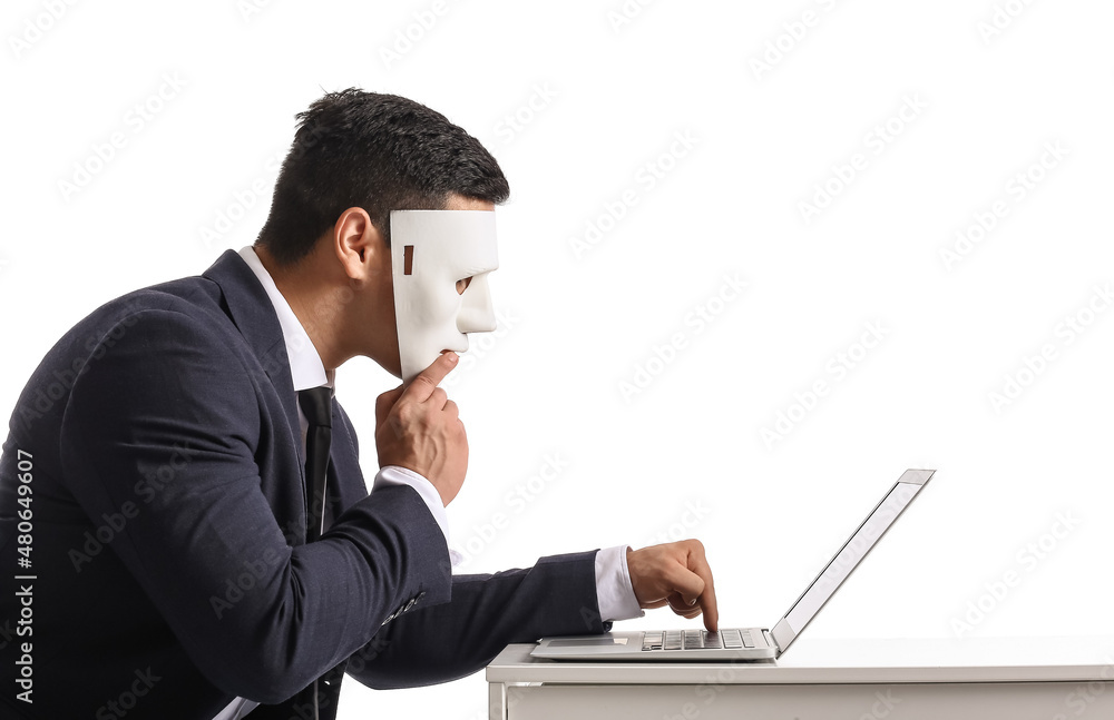 Poster hacker with laptop and mask at table on white background