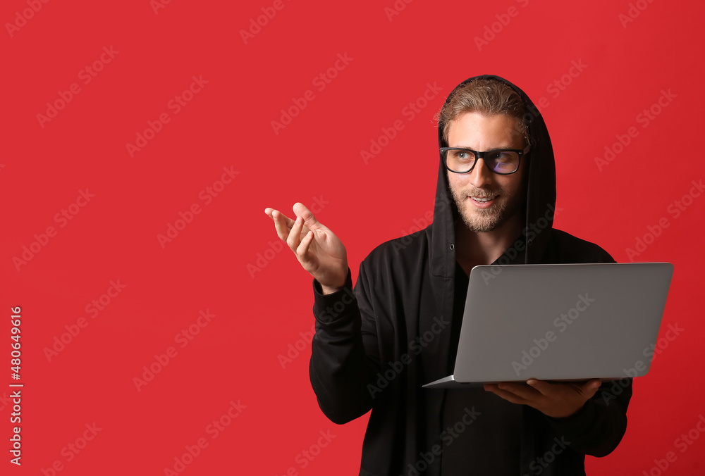 Aufkleber hacker with laptop on color background