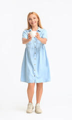 Beautiful mature woman with cup of coffee on light background