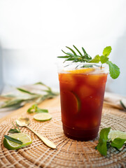 Homemade ice lemon tea with mint and rosemary