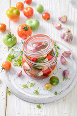 Preparation for pickled tomatoes with garlic, horseradish and dill.