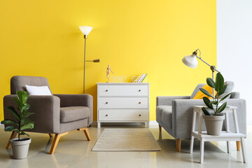 Interior of stylish living room with armchair, sofa and lamps
