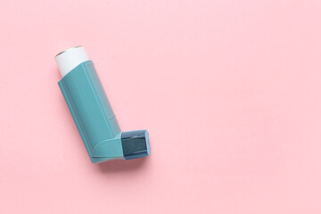 Modern asthma inhaler on color background
