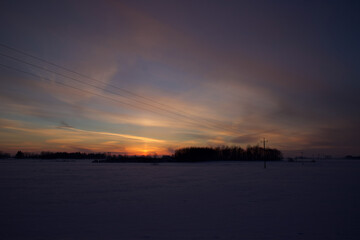 Colorful sky at sunset time with winter scenery.