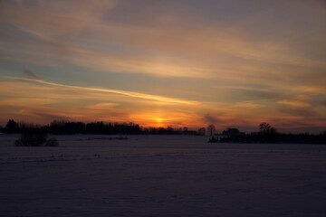 Colorful sky at sunset time with winter scenery.