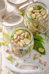 Preparation for pickled broad bean with dill, garlic and horseradish.