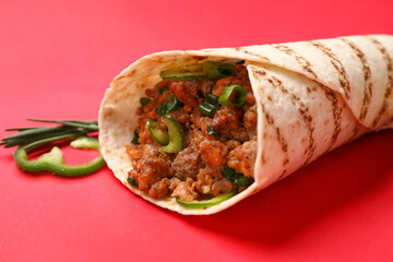 Tasty burrito on red background, closeup