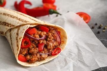 Tasty burrito on table, closeup