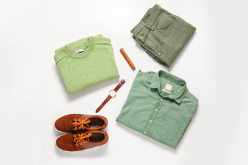 Male clothes, shoes, wristwatch and cigar on white background