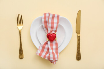 Beautiful table setting for Valentine's Day on yellow background