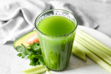 Glass of healthy green juice on table