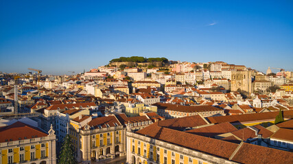 Fototapeta na wymiar Lisbon, Portugal - January 13, 2022: Aerial drone view of Commerce Square in Lisbon, Portugal. Sao Jorge Castle in the background. Winter sunset.