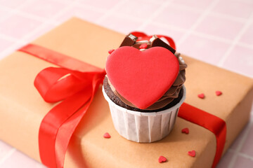 Tasty chocolate cupcake and gift box for Valentine's Day on table