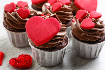 Tasty chocolate cupcakes for Valentine's Day on table, closeup