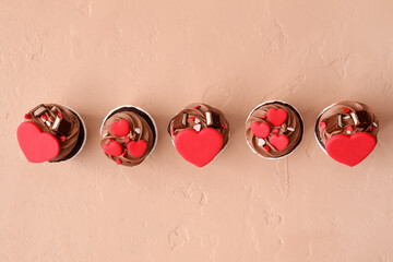 Tasty chocolate cupcakes for Valentine's Day on beige background