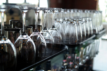 Transparent wine glasses and cups displayed upside down