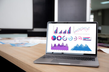 Display monitor of laptop computer with graph chart of investment and profit with financial in conference room at office, digital marketing, report stock and funds, income and expense of business.