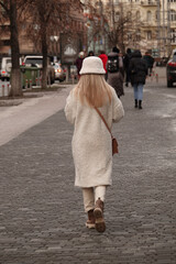 Blonde girl walking down the street