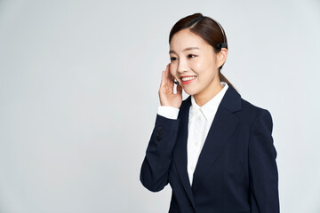 Young telemarketer business woman posing in studio shot
