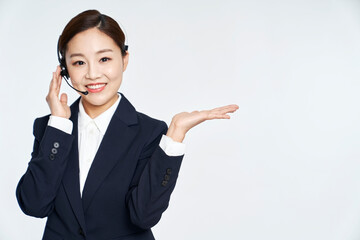 Young telemarketer business woman posing in studio shot