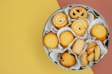 Candy Box with Danish Butter Cookies Isolated multicolored background, top view.