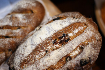 The rugby ball-shaped bread has a lot of sugar powder on its surface.