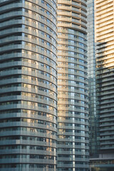 Fototapeta premium close up view of residential condominium towers with glass design
