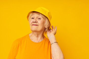 smiling elderly woman happy lifestyle in a yellow headdress close-up emotions