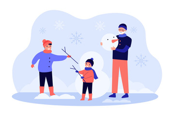 Happy mother, grandfather and child building snowman outdoor