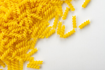 Uncooked fusilli pasta on white background.
Italian food fusilli pasta image for background.
