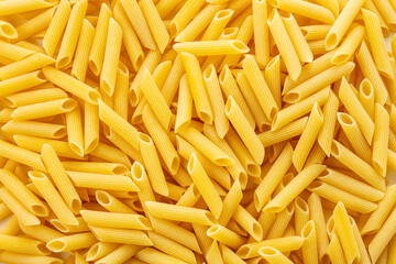 Raw dry penne pasta.
Italian food penne pasta image for background.