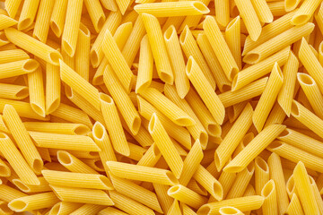 Raw dry penne pasta.
Italian food penne pasta image for background.