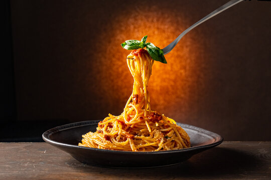 Spaghetti pasta bolognese in black plate.
Italian food image.
