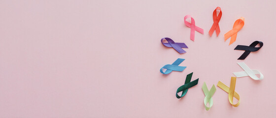 Multicolour ribbons on pink background, cancer awareness, World cancer day, world autism awareness...
