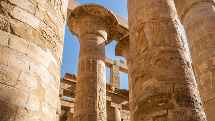 Ancient columns in the Karnak Temple of Luxor. Close-up. Carvings, hieroglyphs are visible. The...