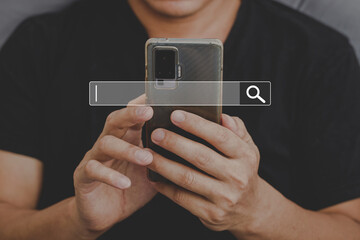 Man using phone searching browsing internet data Information with search bar icon. Networking concept