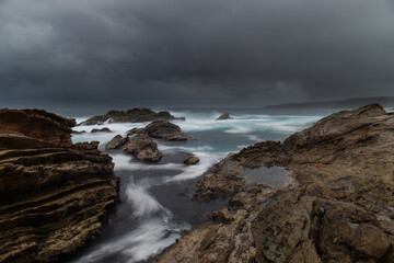 Rocky seascape view with stormy sky.