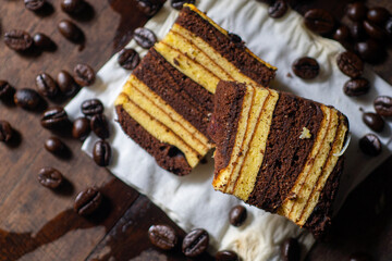 Indonesian slice cake with coffee bean on wooden table