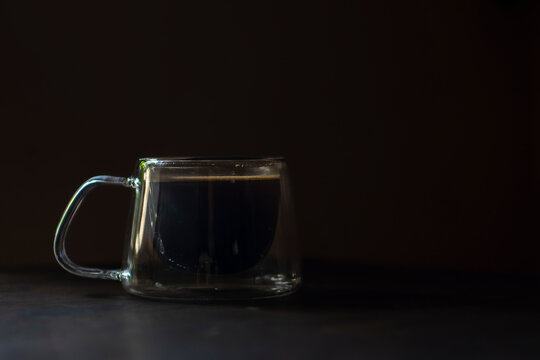 A cup of Indonesian black coffee with blur background, selected focus